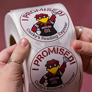 roll of stickers which read "I promised Cocky" to read.