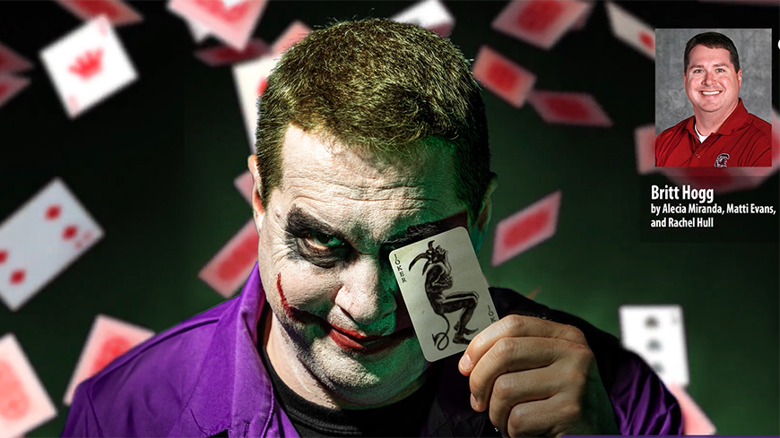 The Joker holding a car over one eye with cards falling in the background