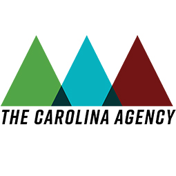 Formal logo - three slightly overlapping triangles, side by side, in the following order from left to right; Green, Blue and Red. Where the triangles overlap it is colored Black. Beneath the triangles is written The Carolina Agency.