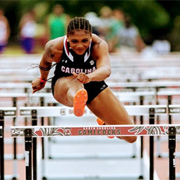 sports photo - track and field female athlete jumping over a bar