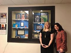 Ashley Quam and Jennifer Morrison pose in front of the display.