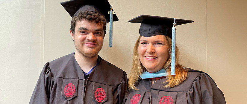 two people wearing graduation caps and gowns