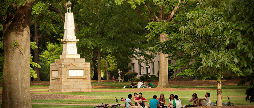 The Horseshoe Monument. Several groups of students are in the foreground.