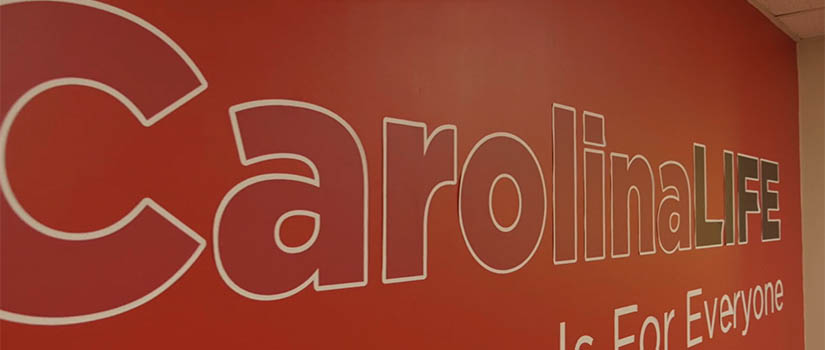 Garnet wall that reads "CarolinaLIFE"
