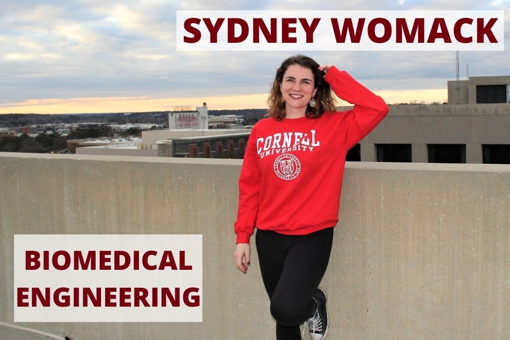 Sydney stands atop a parking garage wearing a Cornell sweatshirt in downtown Columbia