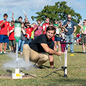 student launches bottle rocket for crowd