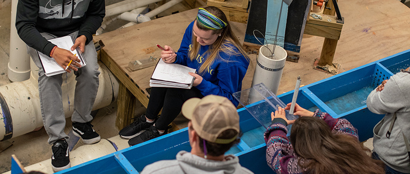 Overhead view of students in water resources lab
