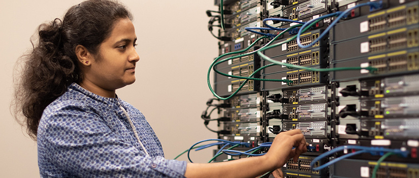 female student works on a computer network