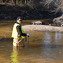 researcher stands in river