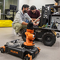 two students program a robot