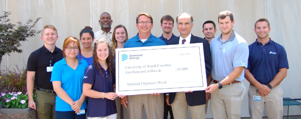 Students and faculty pose with an oversized check from Dominion