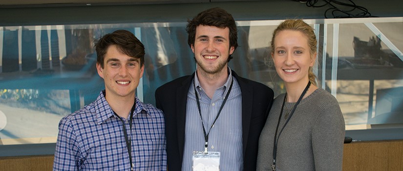 three students pose