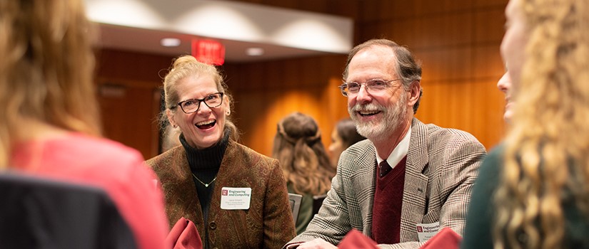 two people laughing at a table