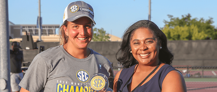 Ingrid Martin hold trophy with SEC rep