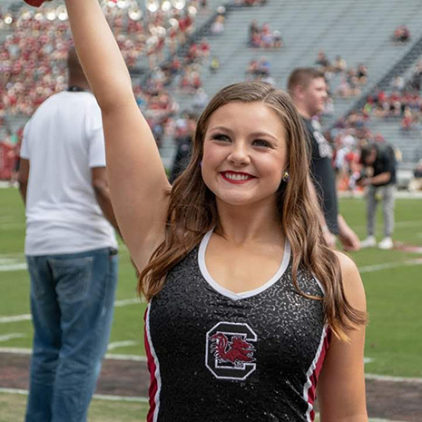 Abby Delnoce dancing at a home football game