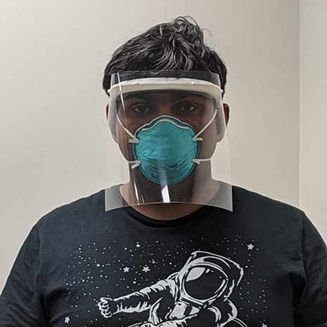 Graduate student wears 3D printed face shield