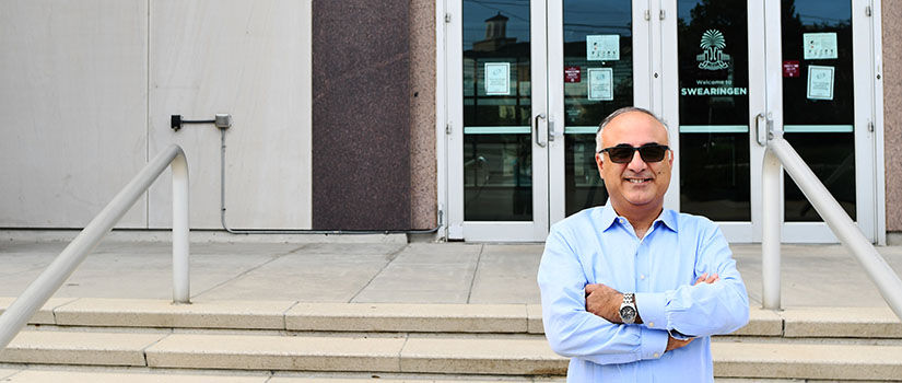 Electrical Engineering Distinguished Professor Adel Nasiri in front of the Swearingen Building