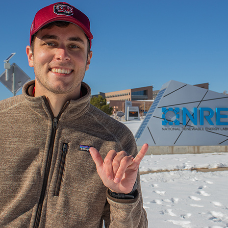 Drew Pereia stands outside the NREL building