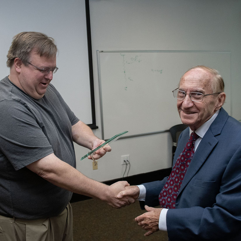 Chemical Engineering Chair Chris Williams presents an award to retiring Professor Branko Popov