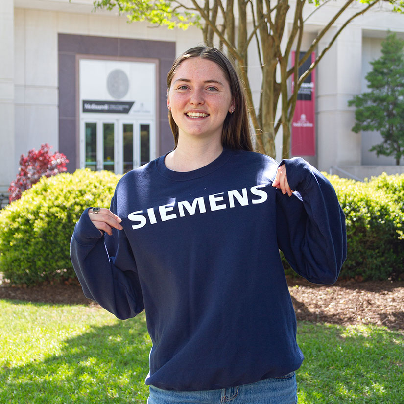 Hanna Lutz in the green space near the entrance to the Swearingen Engineering Center. 