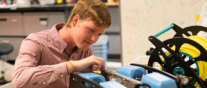 a student works on a robot