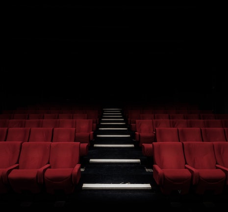Empty movie theater full of red seats