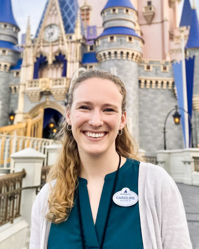 Caroline Cates smiling with Disney castles in the background.