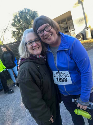 Jan Smoak hugging Jennifer Bess at a 5K race.