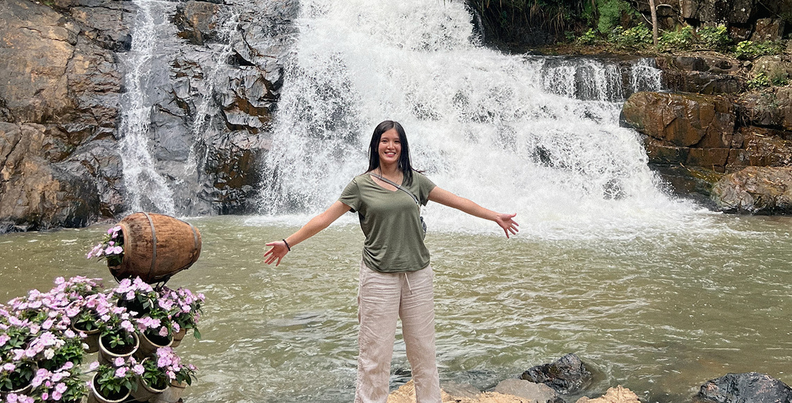 Tam Dinh in front of a waterfall