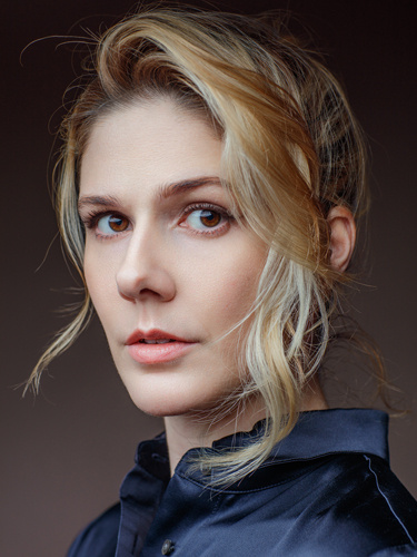 Headshot of woman wearing a navy blue velour blouse.