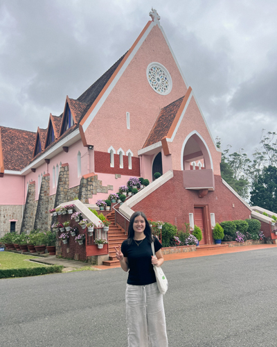 Tam Dinh in front of a building