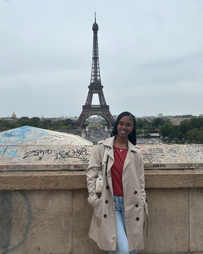 Karmyn Carter in France with the Eiffel Tower in the background.