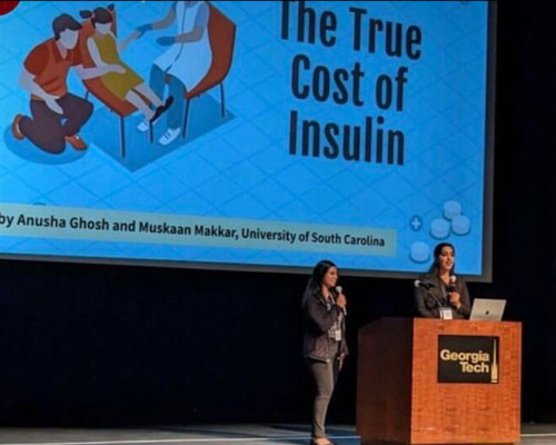 Two women standing at a podium