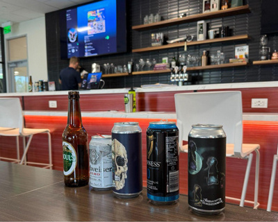 Close up of various nonalcoholic beverages lined up on a table.