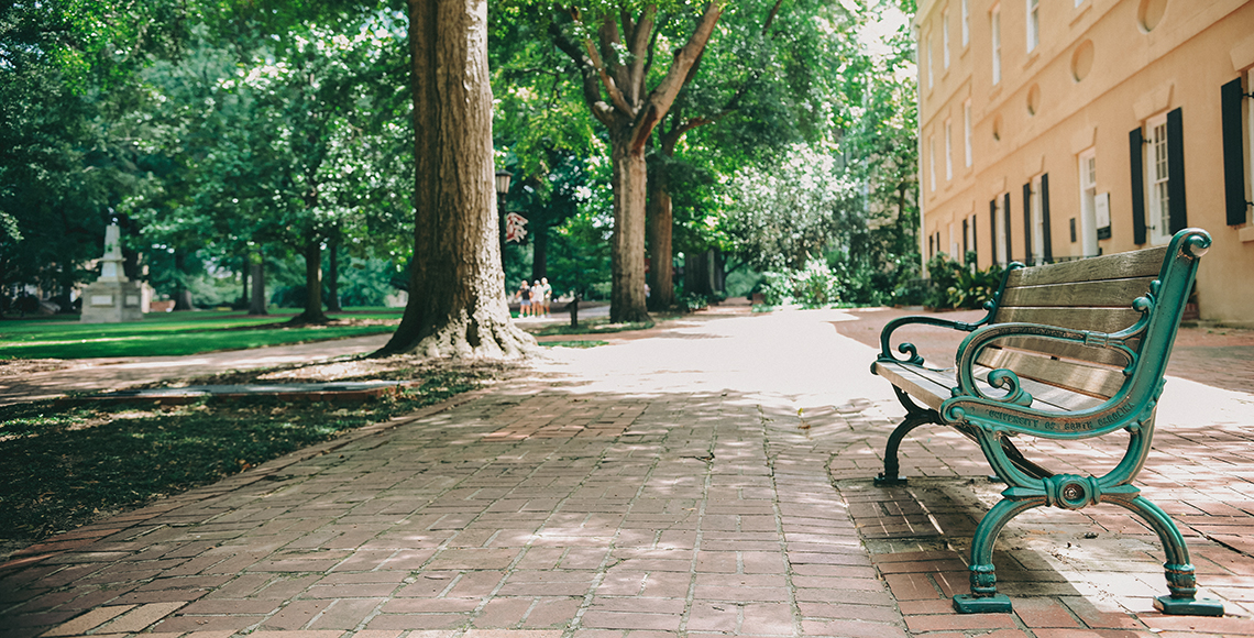 A wooden bench along the brick path on the University of South Carolina's Historic Horseshoe