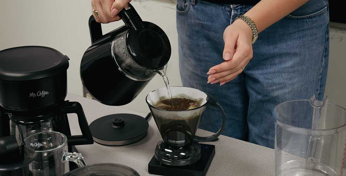 A student brewing pour over coffee during the lab portion of the class to test her lab group’s design.