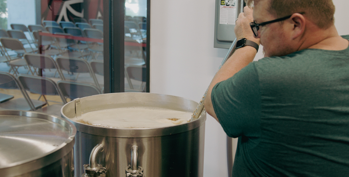 Person stirring beer