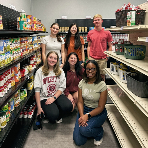 Students posing in a grocery aisle.