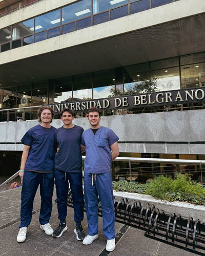 Jake Acrement with two classmates outside the Universidad de Belgrano in Argentina