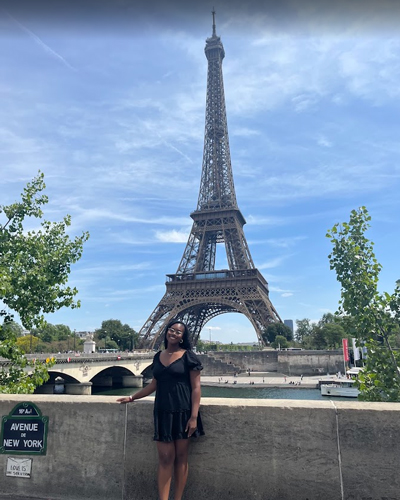 Desiree White standing in front of the Eiffel Tower.