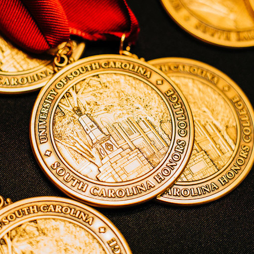 a group of Honors medallions against a black background