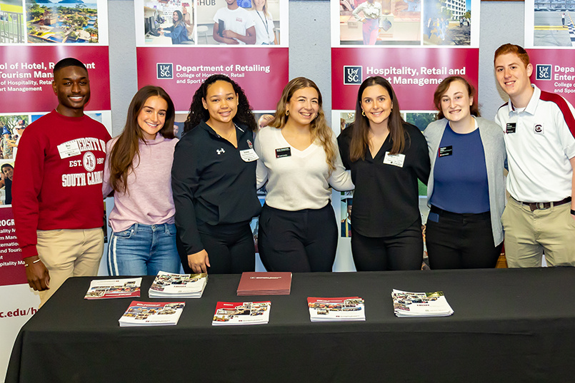 Seven members of HRSM's Leadership Program pose for a photo while assisting at Admitted Student Day.
