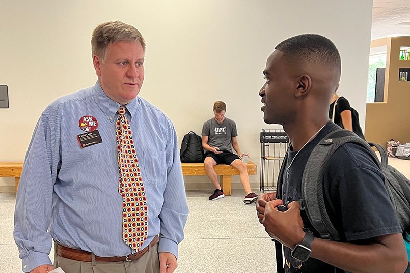 Collin Crick speaks with an HRSM student on the first day of fall classes on the first floor of the Close-Hipp building.