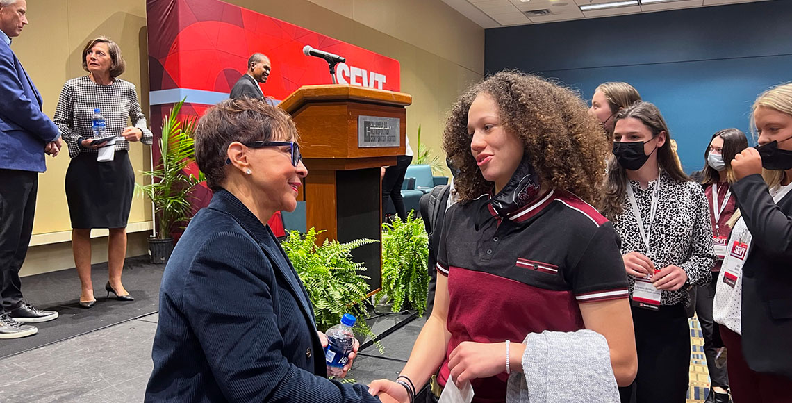 SEVT 2021 Keynote Speaker and Pioneer Award Winner Sheila Johnson shakes hands with a conference attendee. Johnson is CEO of Salamander Hotels and Resorts and president of the WNBA’s Washington Mystics.