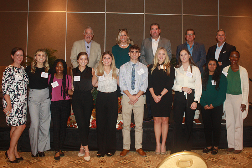 A group of students, faculty, staff pose for a photo with executives from Innisbrook, a Salamander Resort in Palm Harbor, Florida.