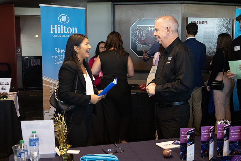 A student speaks with a recruiter from Hilton Hotels and Resorts during the Experience Expo job fair.