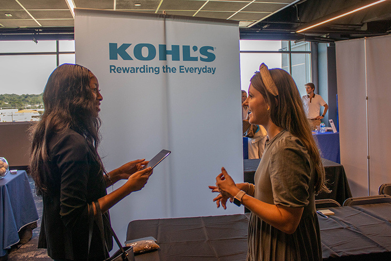 A student talks with a recruiter from Kohl's at the Experience Expo job fair.