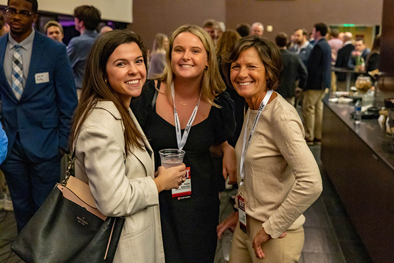 Two College of HRSM students pose for a photo with senior instructor Susan O'Malley at the Sport Entertainment and Venues Tomorrow conference over Nov. 16-18, 2022, at the Columbia Metropolitan Convention Center.