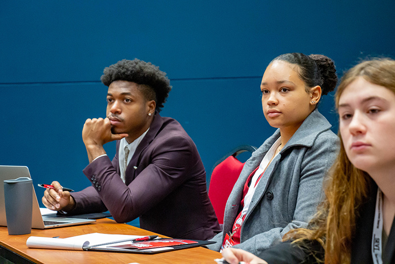 A trio of students watch a research presentation at the Sport Entertainment and Venues Tomorrow conference over Nov. 16-18, 2022, at the Columbia Metropolitan Convention Center.