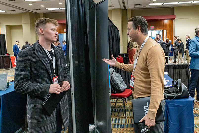 Professor Stephen Shapiro speaks with a student during the career and internship fair at the Sport Entertainment and Venues Tomorrow conference over Nov. 16-18, 2022, at the Columbia Metropolitan Convention Center.